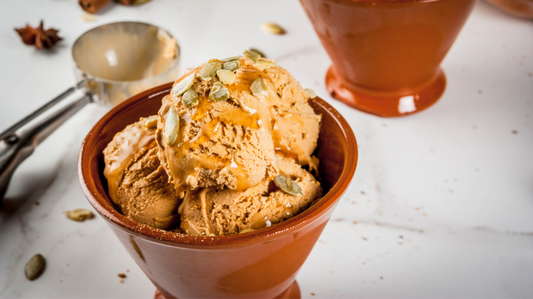 pumpkin pie ice cream served with maple syrup and pumpkin seeds